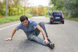 Man crying while sitting on the road