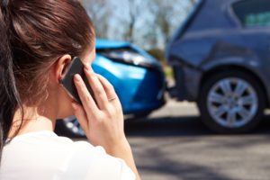 A girl calling from her mobile after car accident